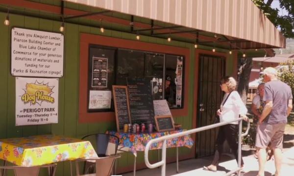 Two patrons walk in to the Dog House snack shack at Perigot Park