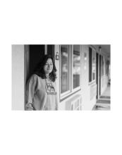 Woman stands in doorway of apartment at The Grove, Arcata